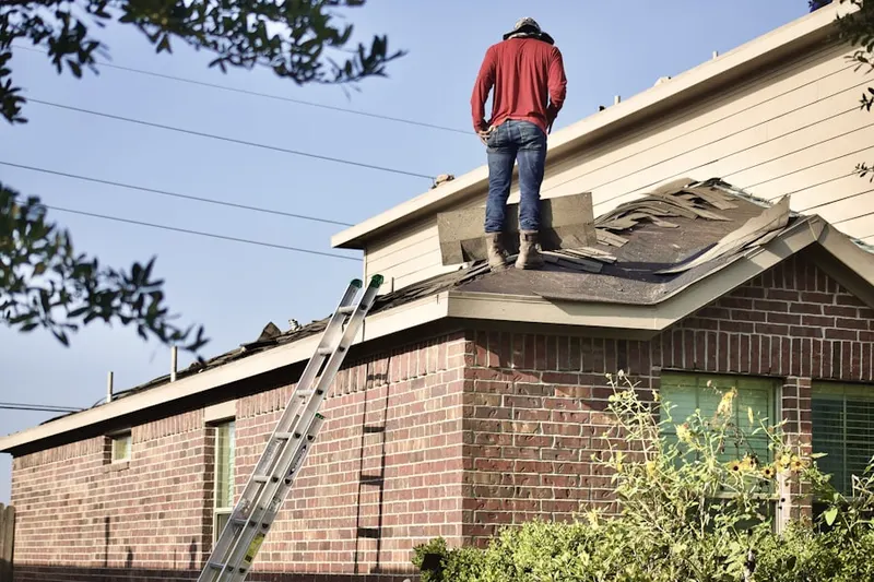 Professional roofer working on a residential roof in Villages of Lake St. Charles